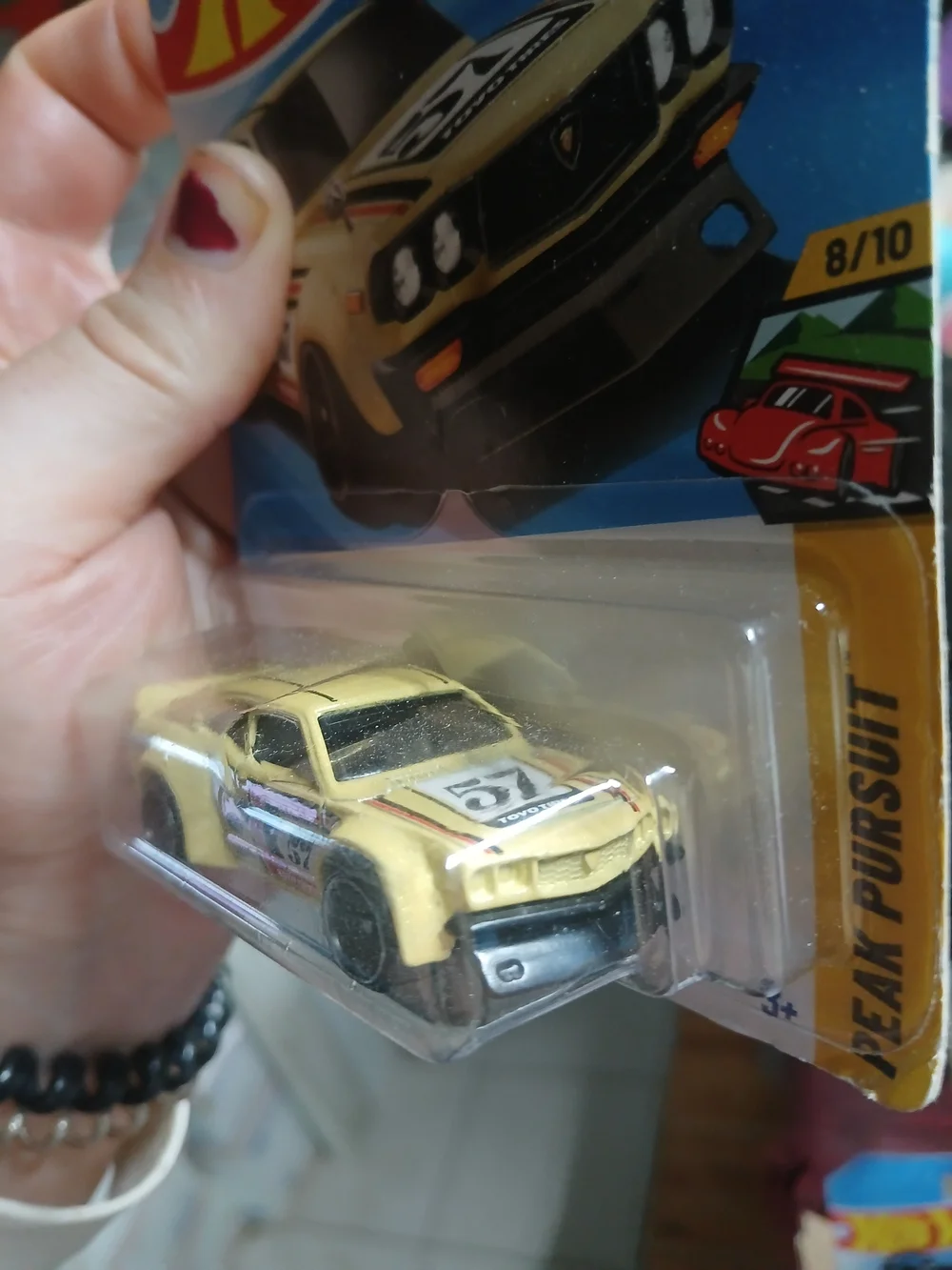 1:64 scale die-cast yellow Mazda RX-3 from the Hot Wheels Peak Pursuit series (n